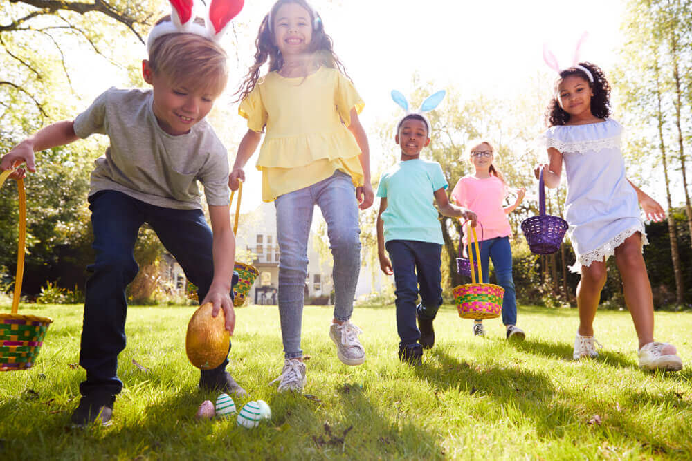 Group of kids looking for plastic Easter eggs outside